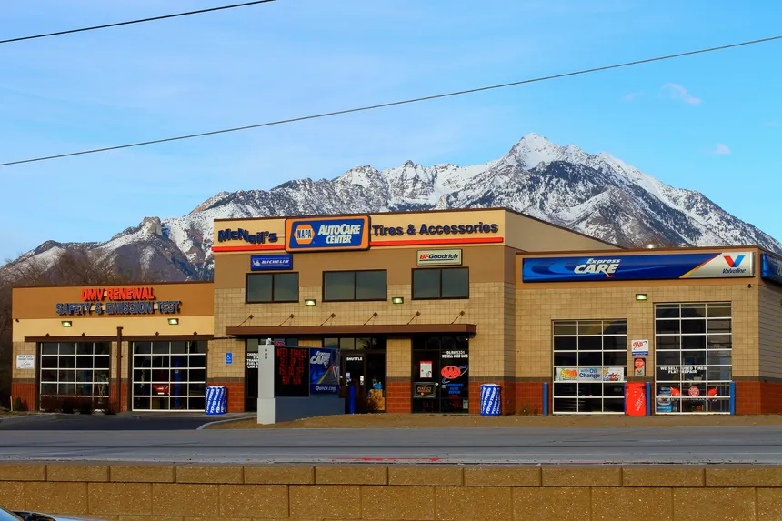 McNeil's Auto Care in Sandy with snow-capped Wasatch peaks behind the building